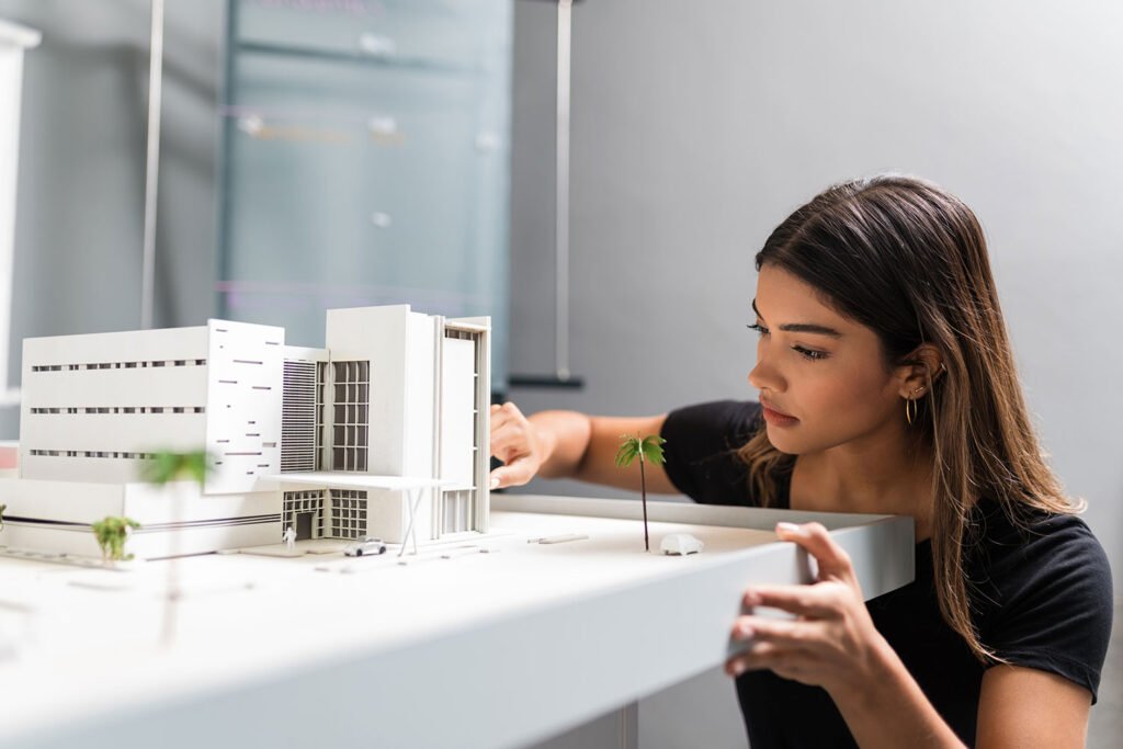 Architect examining modern building model
