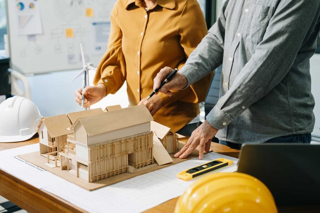 Engineers working over project model
